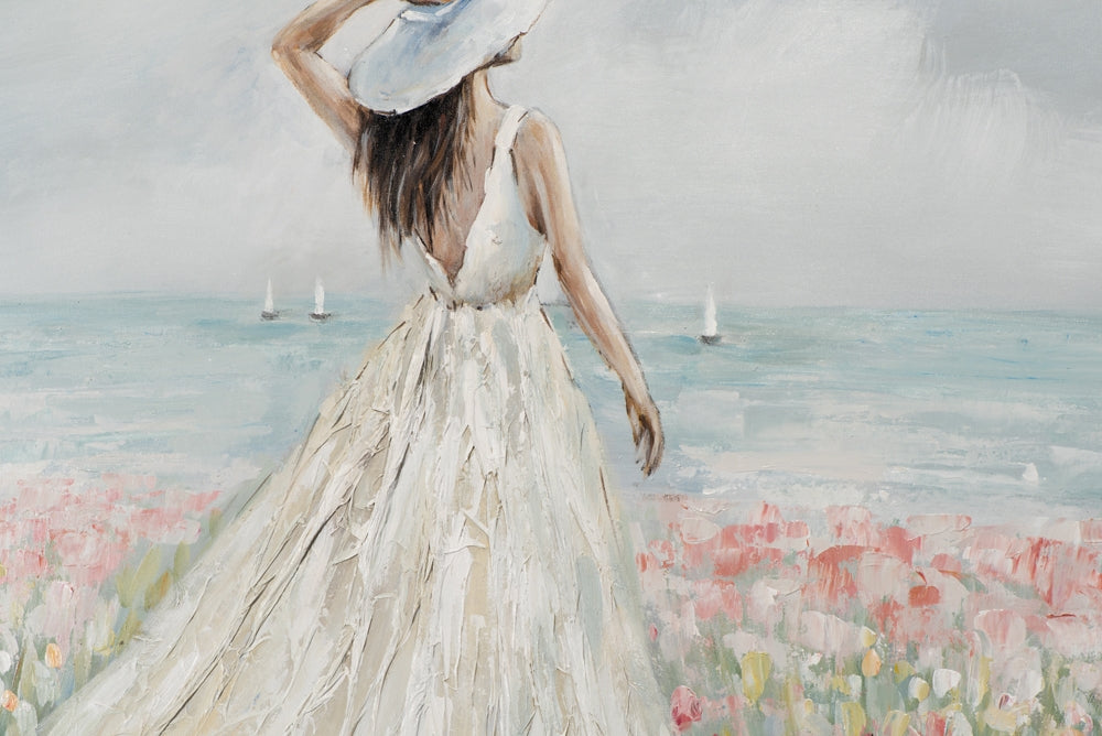 Frau in Blumenmeer im weißen Kleid